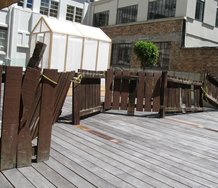 Greenhouse and borrowed fence: works by Ross Forbes and Anthony Cribb on the the terraced rooftop next to CNZ's Auckland offices.