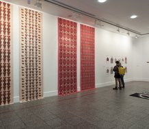 Works on lefthand wall by Sandra Thomson (Dirty Linen, 2006, screenprint on fabric) and Evidence Singlets, works on floor and righthand wall by Michael Reed. Photo: Sam Hartnett.