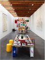Abraham Cruzvillega, Autoconstruccion (resources room), 2010, Books' facsimilar versions, stones, found wooden pieces, glass, maps, steel nails, rope, wheelbarrow, 40 silkscreen prints with selected revolutionary images.