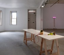 Force Things installed at Gallery Three. On the far wall is Fibre Optic Broom, 2010, by Eddie Clemens. On the table is Soap Box by Michael Grobelny