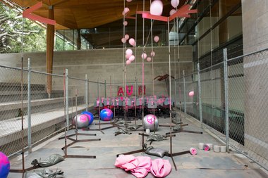 et al., many to many, 2013 (installation detail), roller chairs, signage, metal tubing, sandbags, helium balloons, swiss balls, particle board, original installation in collaboration with Sean Curham one-to-many and many-to-one Khartoum Place 2010.