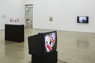 In foreground, Martha Rosler, Martha Rosler Reads Vogue: Wishing, Dreaming, Winning, Spending (With Paper Tiger Television), 1982, videotape converted to digital video, 25:21 min. Courtesy of the artist. Photo: Sam Hartnett