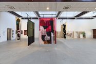 In foreground, Emma Fitts, Fit out for Olivia Spencer Bower, 2015, silk, denim, oilskin, leather, sheepskin, grass. Photo: Daniela Aebli