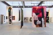 In foreground, Emma Fitts, Fit out for Olivia Spencer Bower, 2015, silk, denim, oilskin, leather, sheepskin, grass. Photo: Daniela Aebli