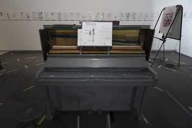 et al. & Samuel Holloway: Upright Piano, 2013, painted and modified piano, annotated score; et al., DE NIEUWE STEM 1-3, 2006, frame, metal box, light fittings, acrylic & oil stick on paper, mp3 paper, headphones, Chartwell Collection, Auckland Art Gallery
