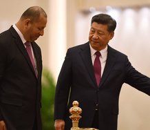 Tonga's King Tupou VI accepts the lead of Chinese dictator Xi Jinping during a visit to Beijing, March 2018. Photograph from the 'South China Morning Post.' 