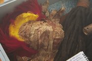 UN)Registered Savages of Aotearoa, Vitrine (detail) Daren Kamali’s hair, collected over 23 years, ongoing, on sulu (Fijian sarong) and masi kuvui (smoked tapa);and Ole Maiava’s Ohe ohe hano ihu Hawaiian nose flute, sketchpad, and Soa o le Maka Kagi mask. 