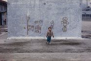 Madeleine Slavick, 'Child and Graffiti, Yuen Chau Kok Housing Estate', from 'Fifty Stories Fifty Images' (Hong Kong: MCCM Creations, 2012) 