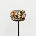 Ruth Watson, Cuff, 2024, souvenirs, vintage metal cuff bracelet, 10 x 10 x 7 cm; stand: 38 x 10 x 10 cm