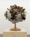 Ruth Watson, Kosmos, 2016-24, souvenirs, aluminium globe on wooden base, 73 x 65 x 65 cm