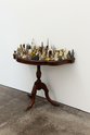 Ruth Watson, The Implacability of Things, 2023=24, souvenirs, vintage side table. 94 x 92 x 45 cm