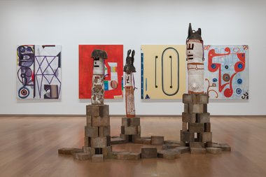 On the floor, Sung Hwan Bobby Park, BTM Ding Deng Dong, 2024. Paintings by Reece King on the walls. Both part of Aotearoa Contemporary, Auckland Art Gallery Toi o Tāmaki, 2024 (installation view)