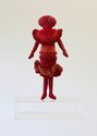 Te Maari, (E) Ruby-Molly Ngātai of the Bowery, 2024, felt, wool/mohair/synthetic fibres (knitted elements), cotton (embroidery), custom acrylic stage. 31 x 18 x 6 cm (figure), 32.8 x 25 x 14 cm (stage)