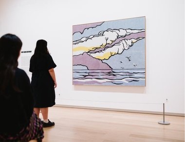 Two visitors admiring the Roy Lichtenstein contribution. It shows smoke trails from fired rockets.